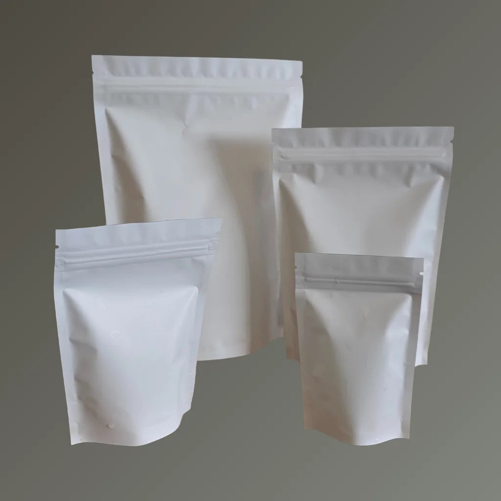 Set of white stand-up pouches on a gray background