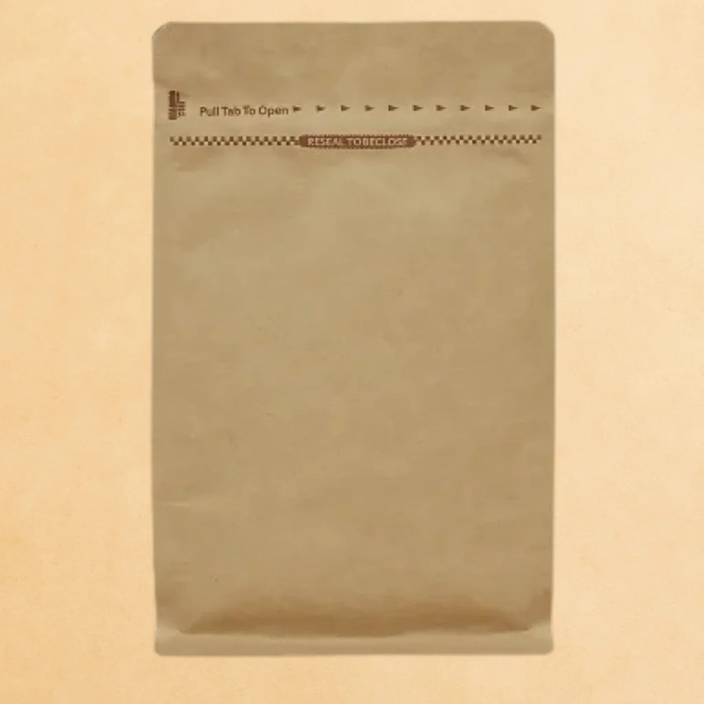 Brown Kraft coffee pouch with Rip n Zip opening and resealable closure, displayed upright against a beige background.