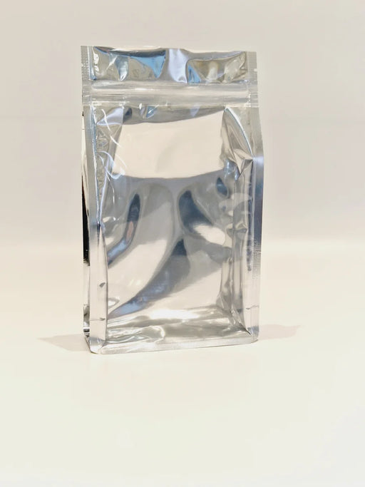 A resealable clear front chrome bacl square bottom pouch.