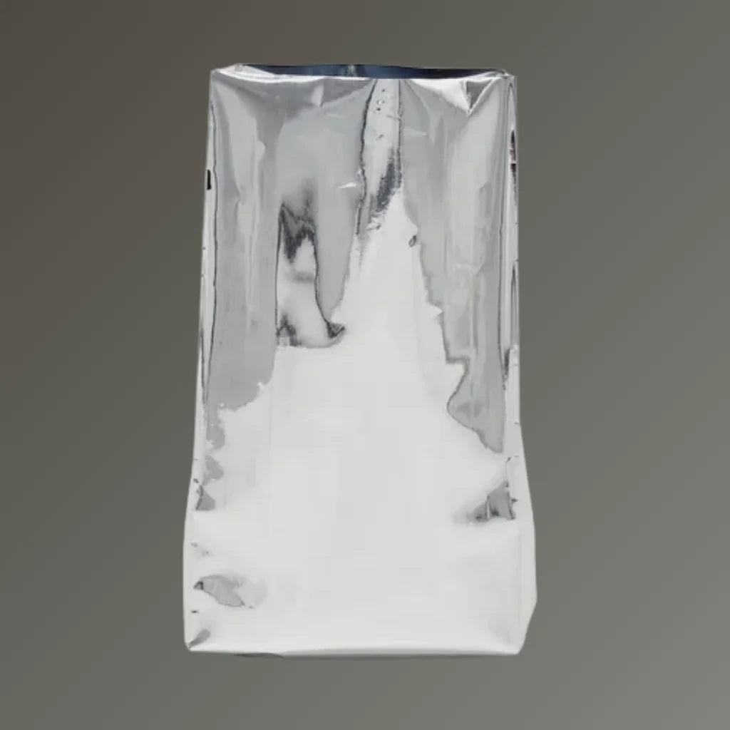 Chrome side gusset open top coffee bag standing upright on a grey background.