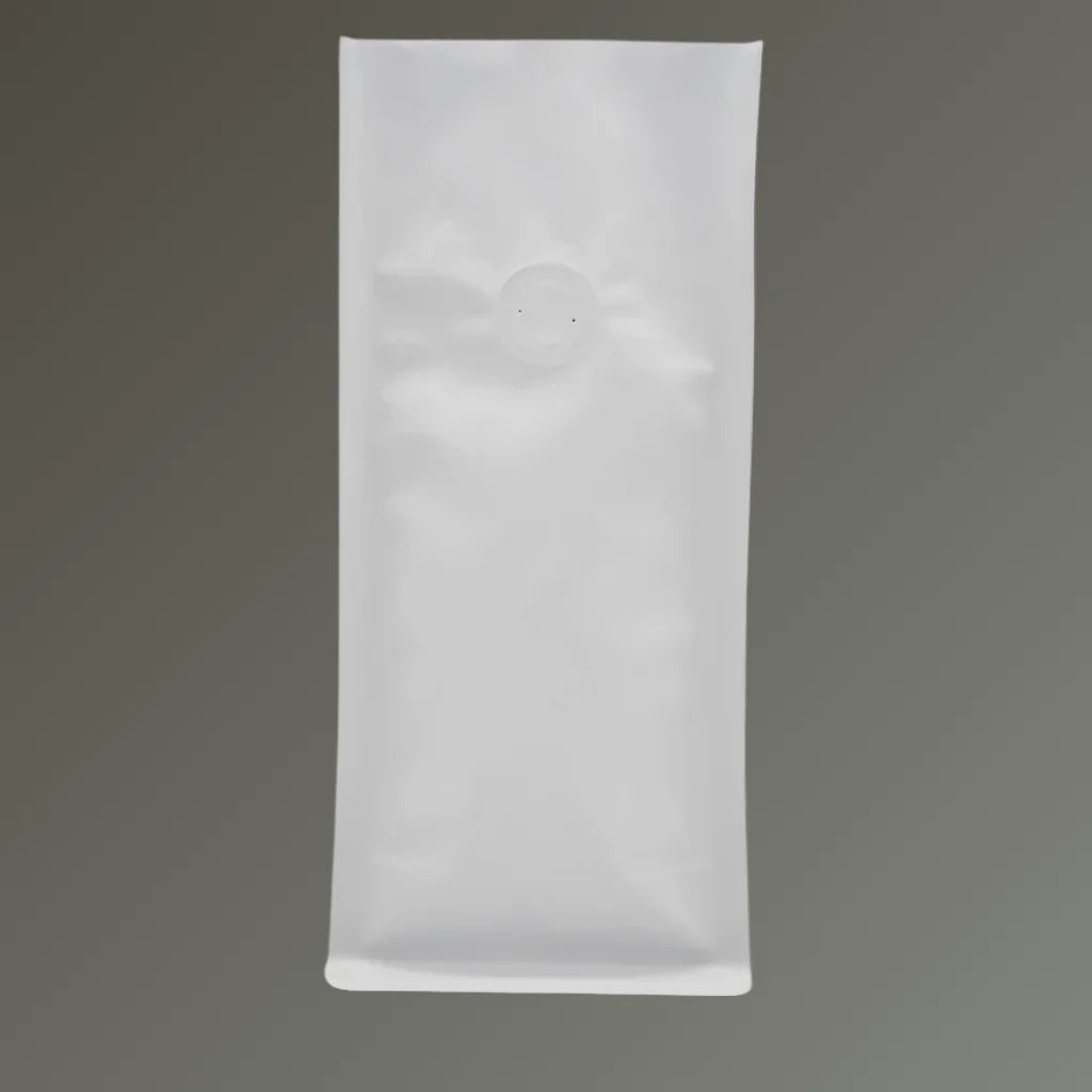 White open top coffee pouch with one-way degassing valve, standing upright on a grey background.