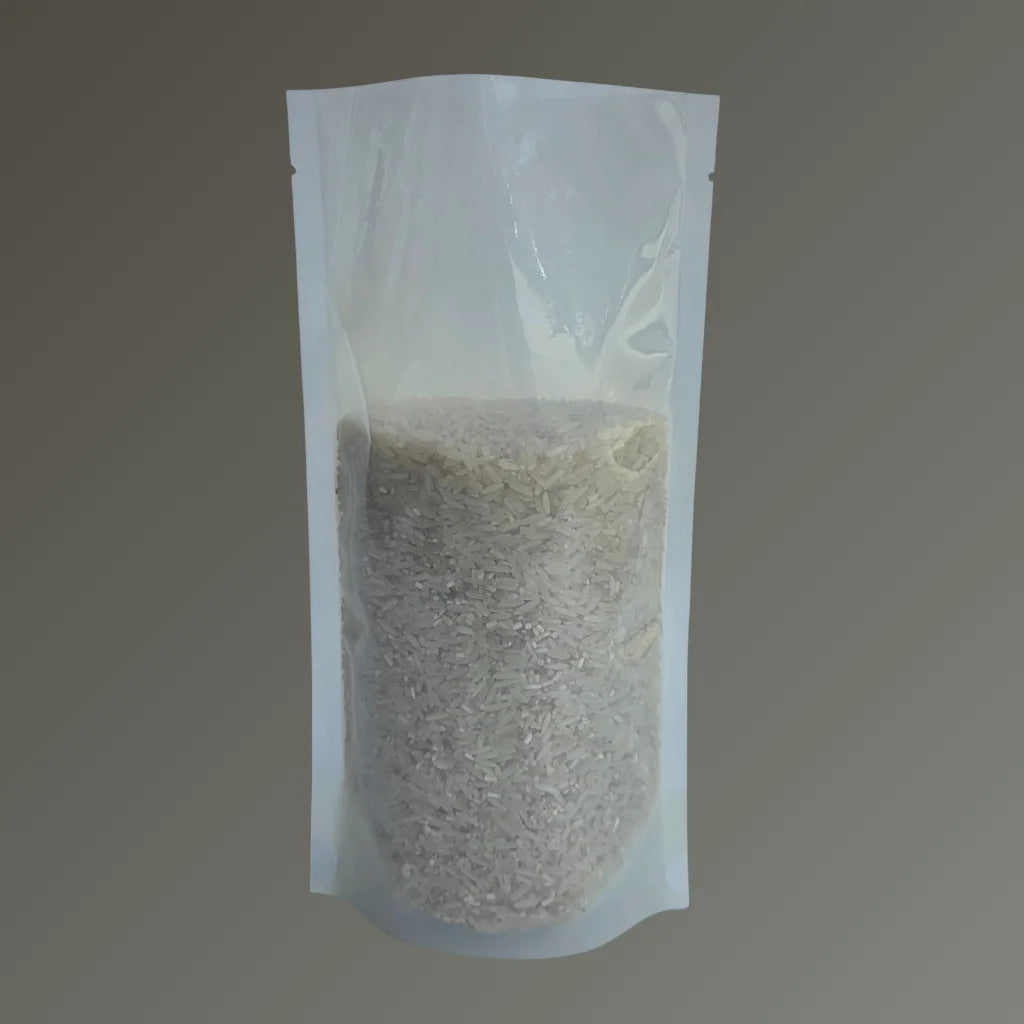 Compostable freezer proof stand up pouch filled with rice, displayed against a plain grey background.