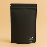 Black stand up pouch with a resealable zipper, displayed against a beige background, featuring the 