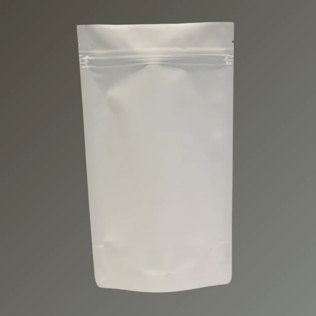 Matt white resealable stand up pouch displayed against a neutral grey background.