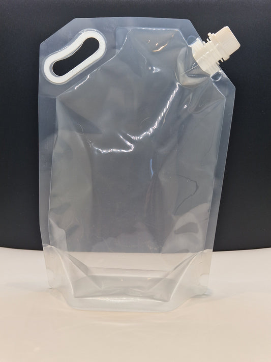 Clear plastic spout pouch with top corner spout and built-in handle, displayed upright against a dark background.