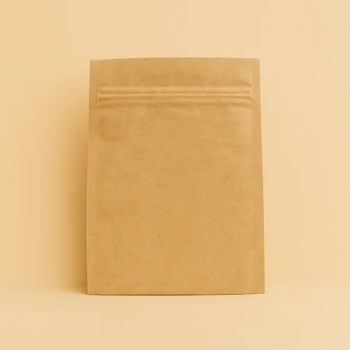 Brown kraft paper sachet with resealable zipper, displayed upright against a matching beige background.