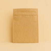Brown kraft paper sachet with resealable zipper, displayed upright against a matching beige background.