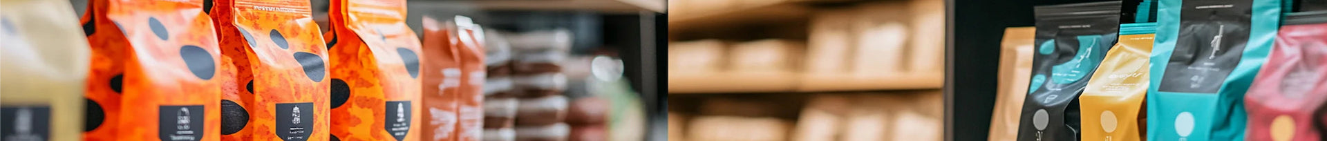 Row of coffee bags with visible branding in a store setting