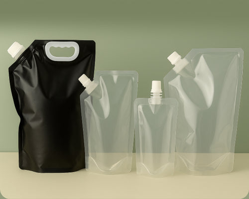 Set of black and clear stand-up pouches with various closures on a green background