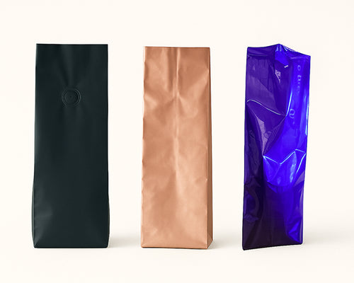 Three metallic coffee bags in black, bronze, and blue on a white background