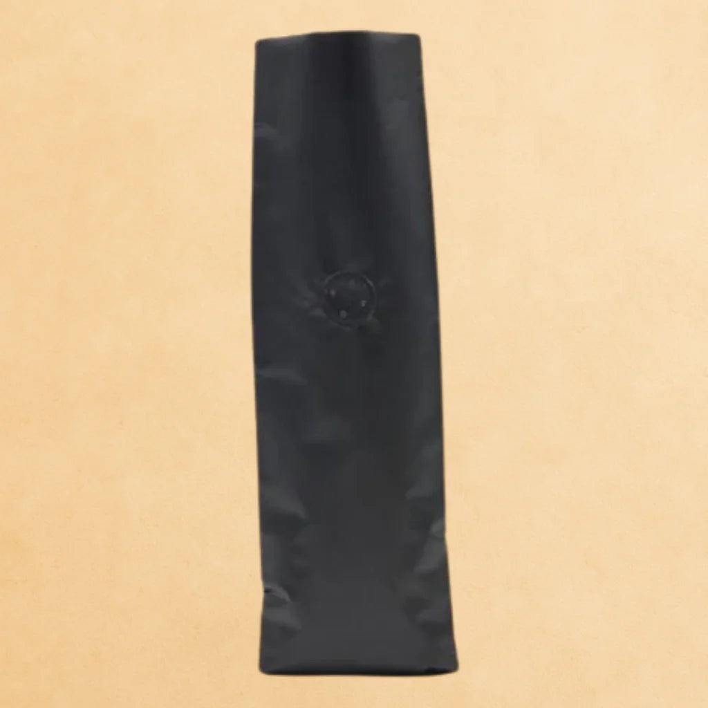 Front view of a black open top coffee pouch with a side gusset and degassing valve.