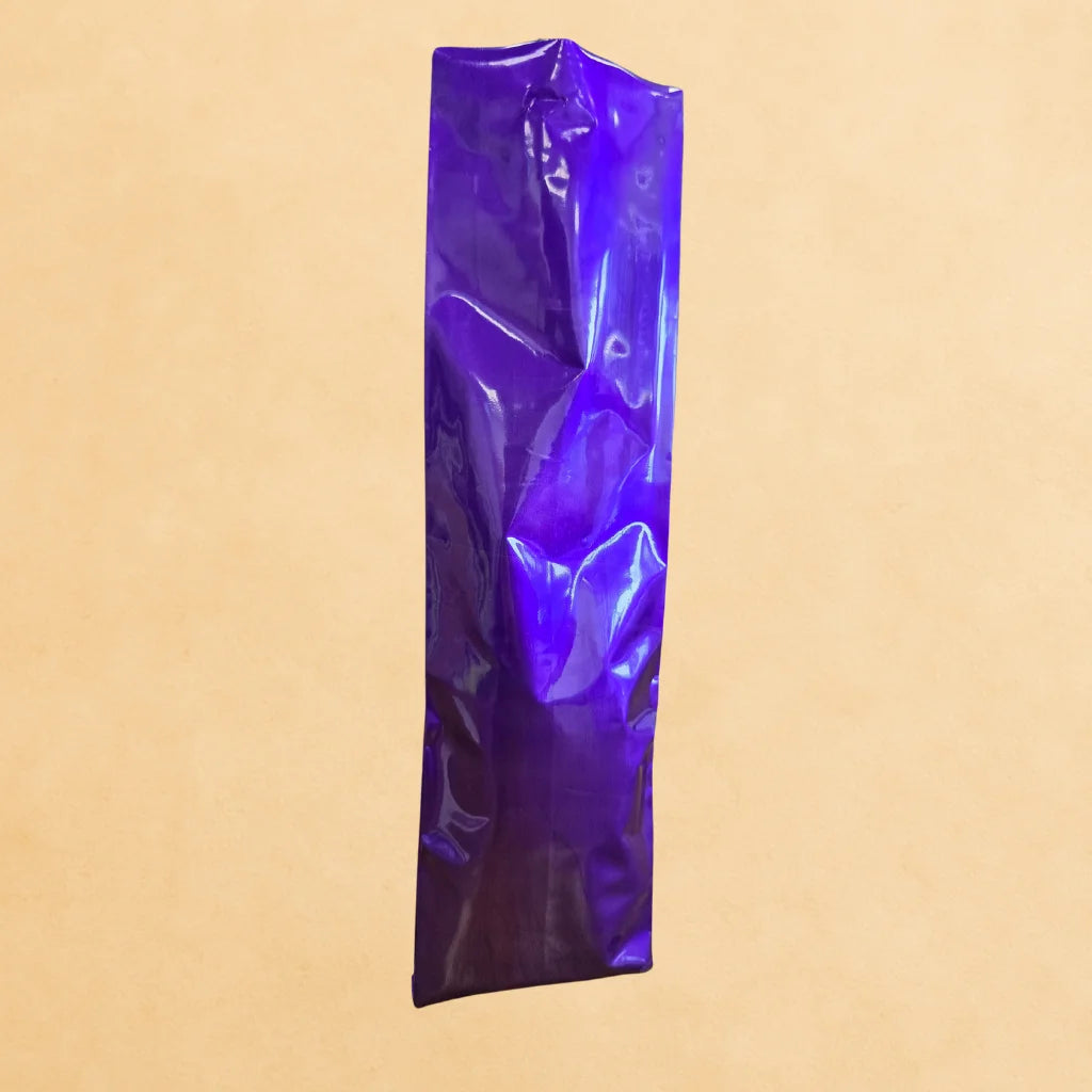 Purple side gusset coffee bag with open top, displayed upright against a beige background.