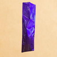 Purple side gusset coffee bag with open top, displayed upright against a beige background.