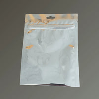 Foil 3 side seal resealable open bottom sachet with Euro hole, shown upright on a grey background.