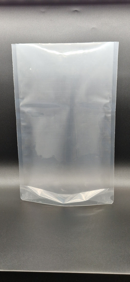 Clear open top stand up pouch displayed upright against a dark background, shown empty and unsealed.