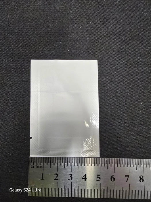 Foil 3 side seal with open bottom pouch with a ruler showing the measurement of the width